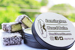 Load image into Gallery viewer, Image of Bondi Beard Co. Lamington Beard Balm in 90g container with lamingtons in background.
