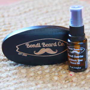 Image of Bondi Beard Co. Laidback Lime Beard Oil and branded boar brush sitting on hessian surface.