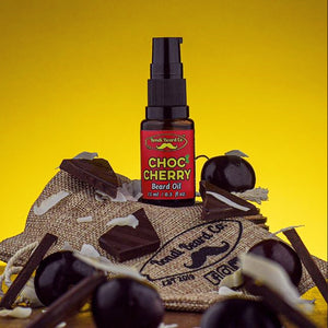 Image of Bondi Beard Co. Choc Cherry Beard Oil in brown spray bottle sitting on branded hessian bag and decorated with dark cherries and dark chocolate shards.