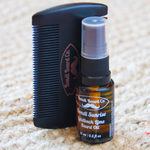 Load image into Gallery viewer, Image of small black atomising bottle of beard oil with a black two-sided comb, both with Bondi Beard Co. branding and sitting on a fibrous mat
