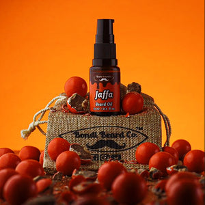 Image of Bondi Beard Co. Jaffa Beard Oil spray bottle, sitting on branded hessian bag, and surrounded by chocolate orange confectionery, with bright orange background.