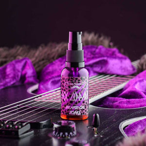Image of Bondi Beard Co. Sex Leppard beard oil with bright purple leopard print label, spray bottle is placed on a black electric guitar and bright purple velvet fabric in background.